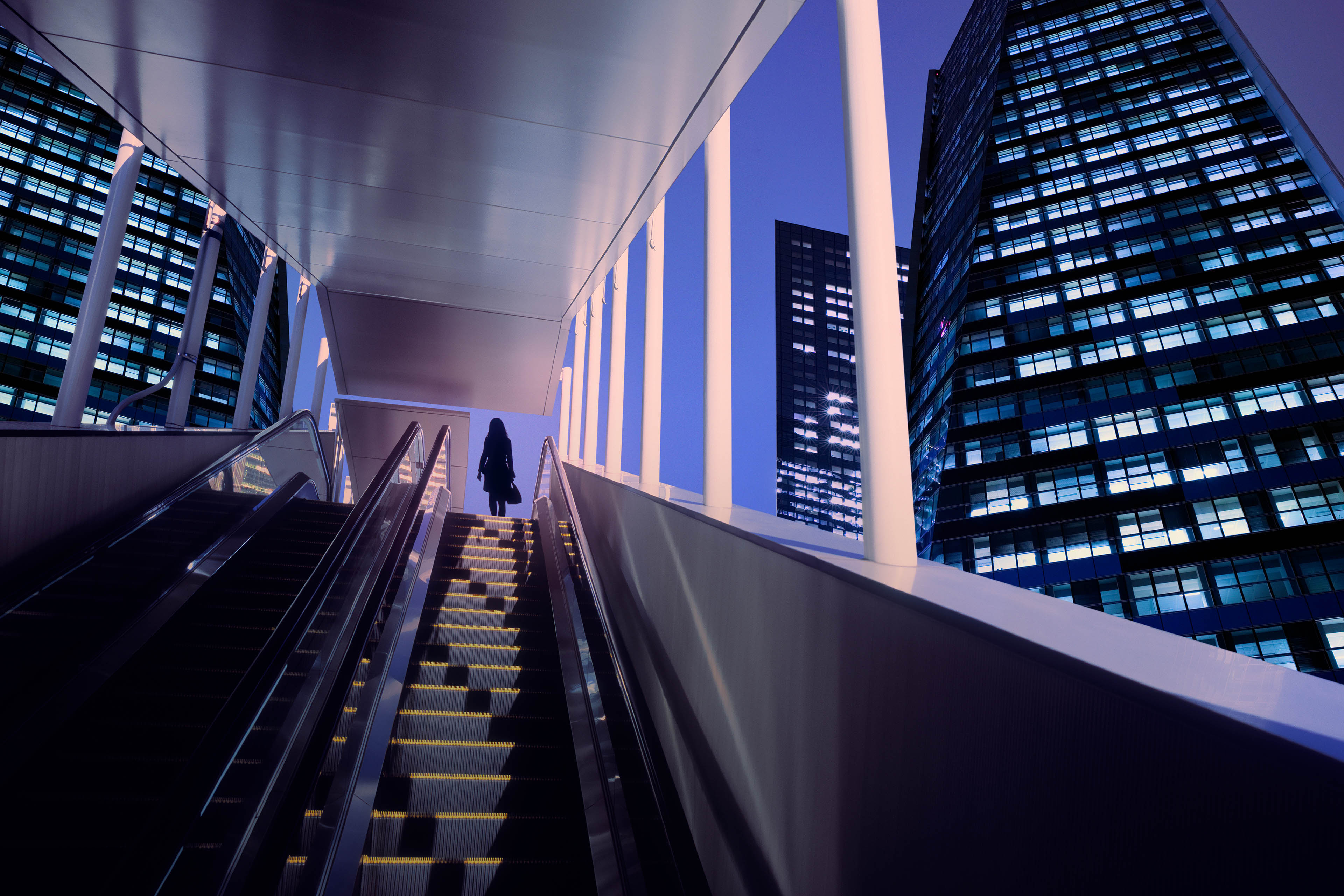 Businesswoman on top of moving escalator