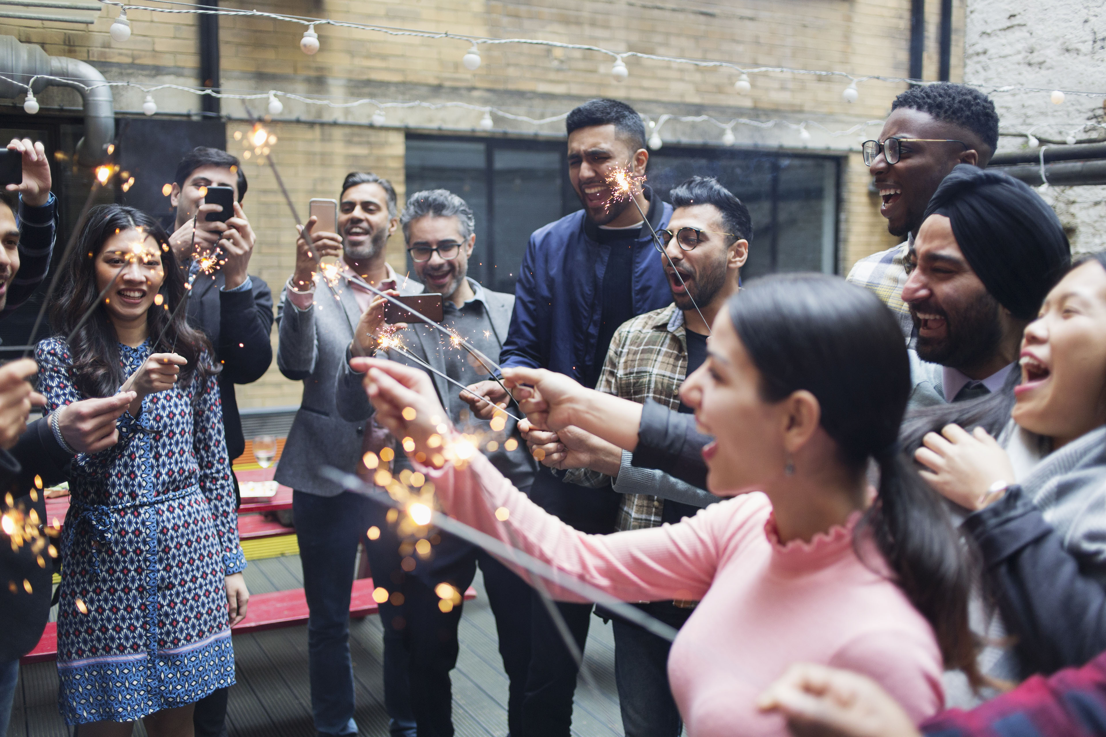 ey-friends-enjoying-party-celebrating-with-sparklers