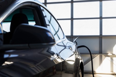 Parked electric car charging in garage